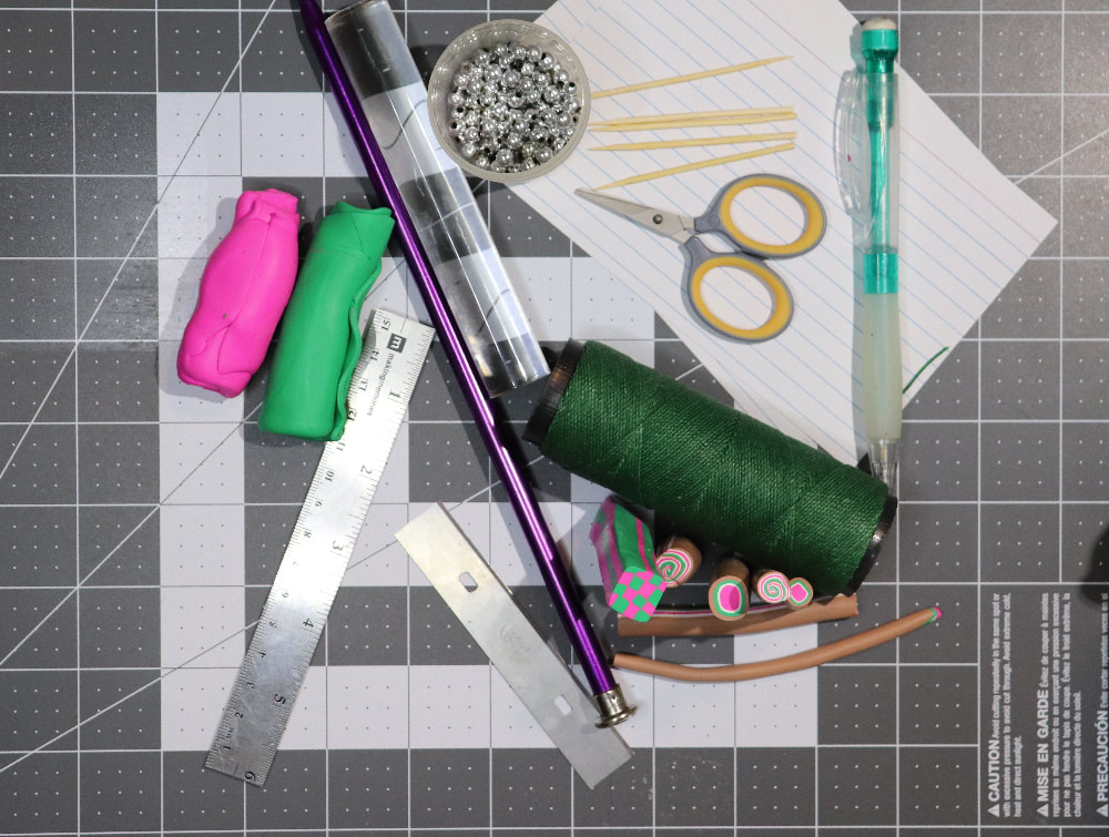 A cutting mat with the listed materials on it.